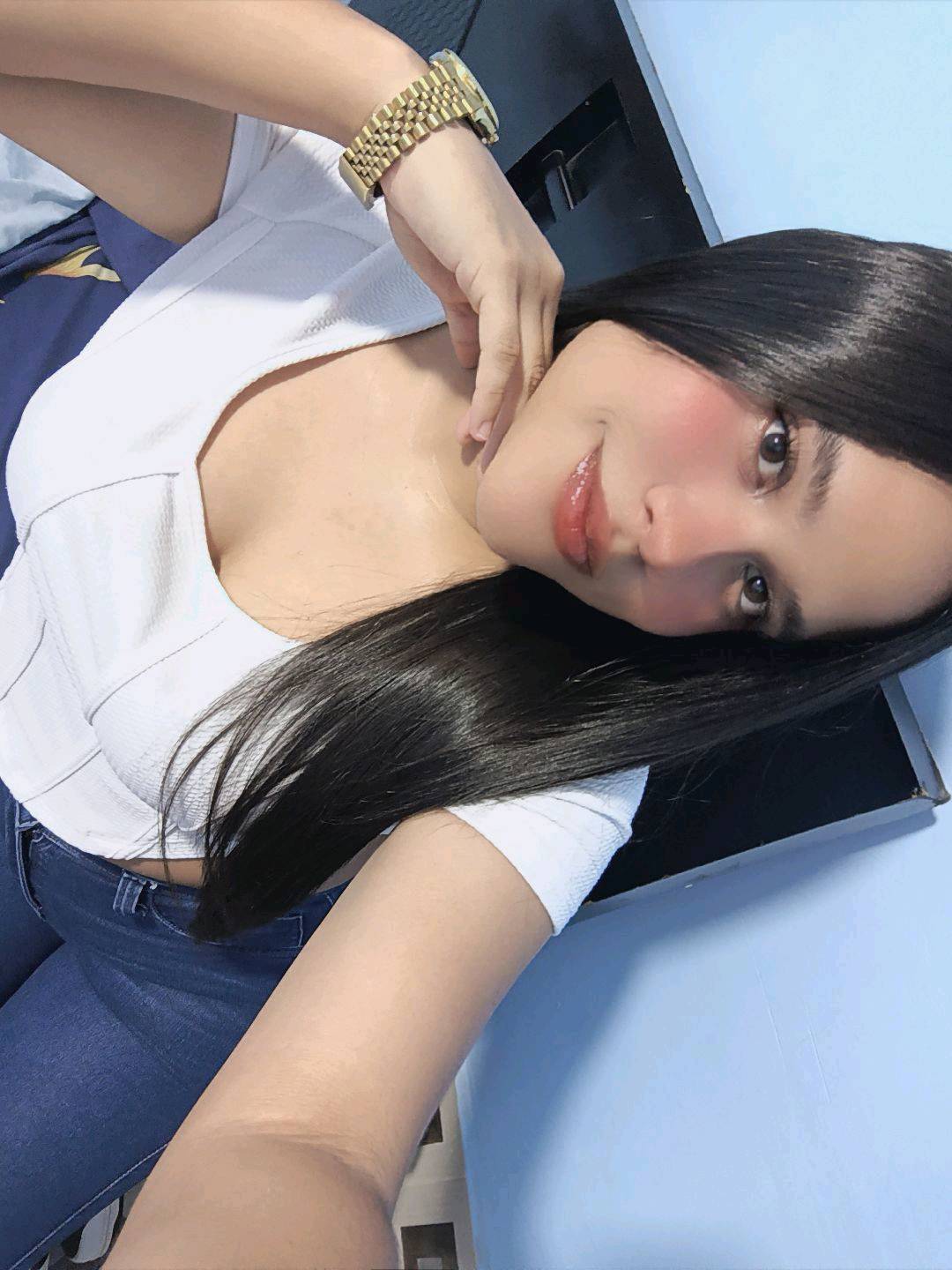 A woman from Ecuador lying back with her phone, sharing only what she chooses